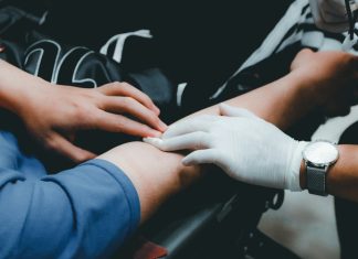 Medicare Liens After a Personal Injury Settlement: How the Reimbursement Math Actually Works person in blue long sleeve shirt holding persons hand