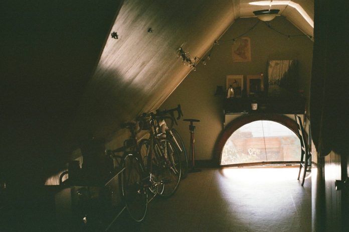 Photo by Mark Pecar black bicycle near brown wooden cabinet