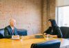 man and woman talking inside office