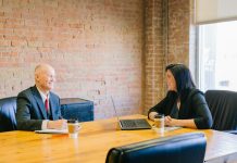 Sole Proprietorship or LLC: What Should New Business Owners Consider? man and woman talking inside office