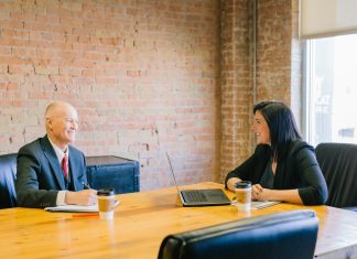 Sole Proprietorship or LLC: What Should New Business Owners Consider? man and woman talking inside office